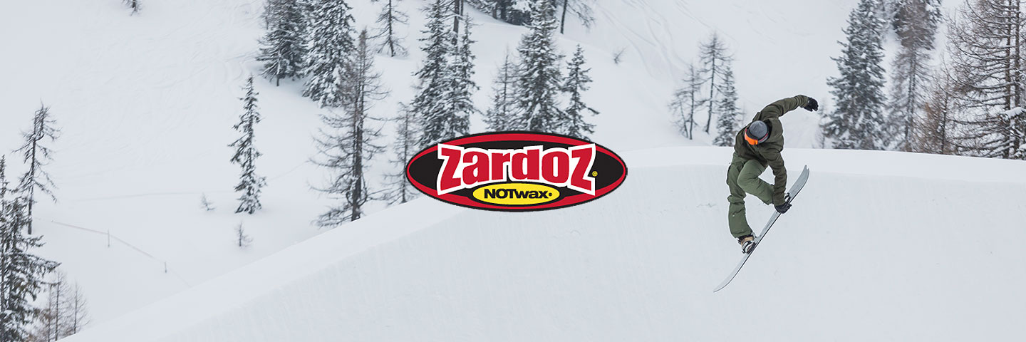 Zardoz logo with snowy scene and snowboarder making a jump