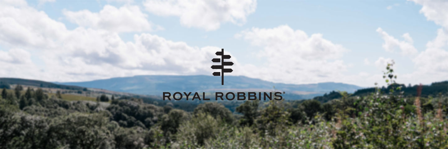 Royal Robbins logo with blue sky and countryside in the background