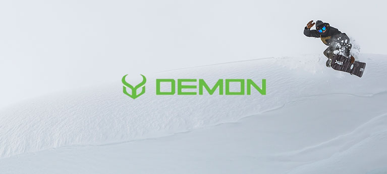 Demon logo with snowboarder in the background