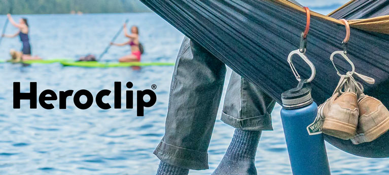 camper using heroclip to hang items on the side of a hammock