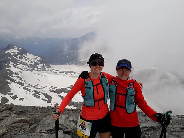 two women celebrating reaching the summit of a mountain