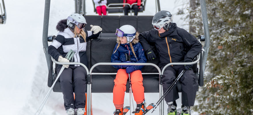 Child and parents on chair lift