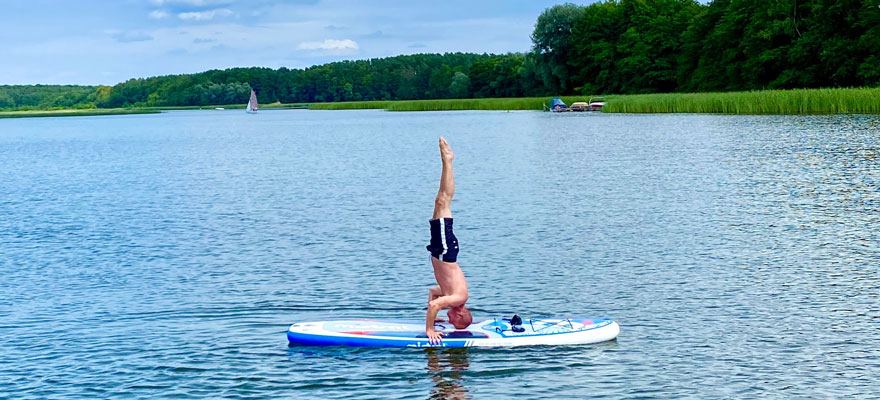 Headstand on a paddle board