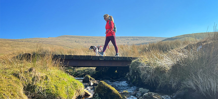 Laura Jones walking with her dog while wearing the adidas TERREX Free Hikers