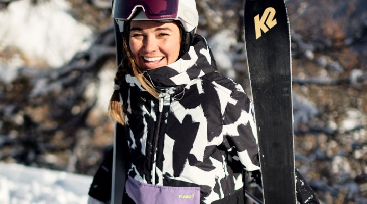 woman wearing planks ski clothing skiing