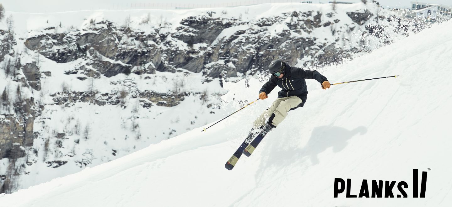 skier wearing Planks clothing with the Planks logo on the left of the image