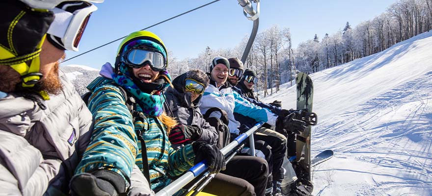 Group of skiiers on a ski lift taking a selfie
