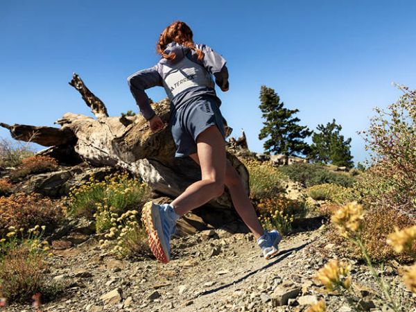 a woman trail running in TERREX shoes