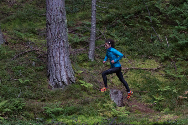 woman running through woods