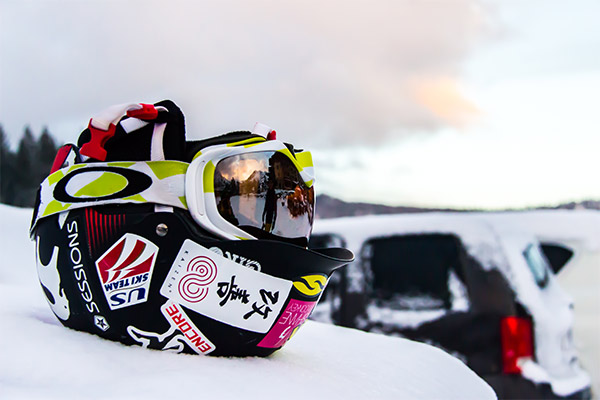 A ski helmet and goggle in the snow