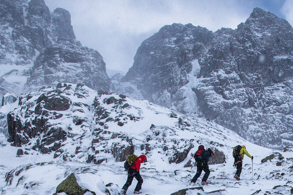 three walkers approaching ice climb