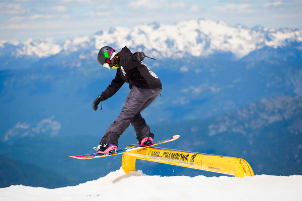 A snowboarder sliding down a rail
