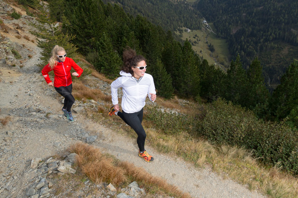 two women running on trail