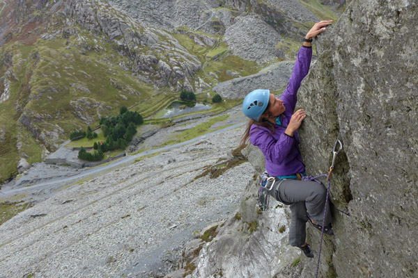 A woman climbing a rock face
