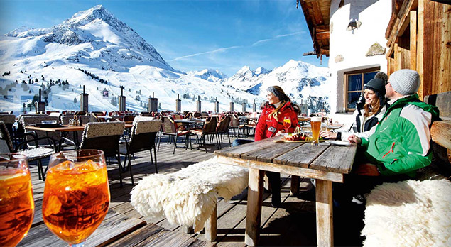 two women drinking wine at an alpine lodge
